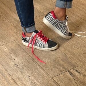 MELINE Italian Zebra Stripe Sneakers with Red and Black Accents.